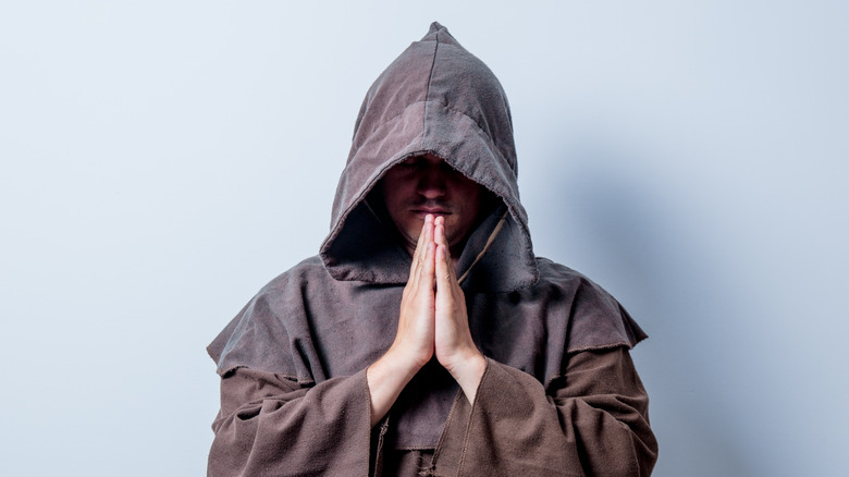 monk with hands in prayer