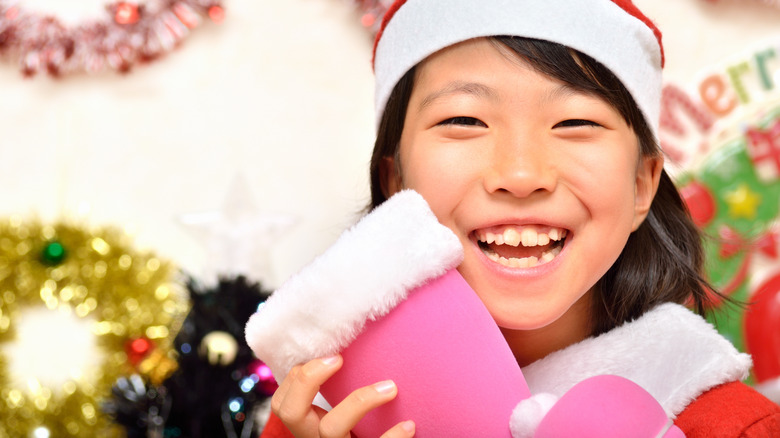 little girl with pink and white Christmas boot