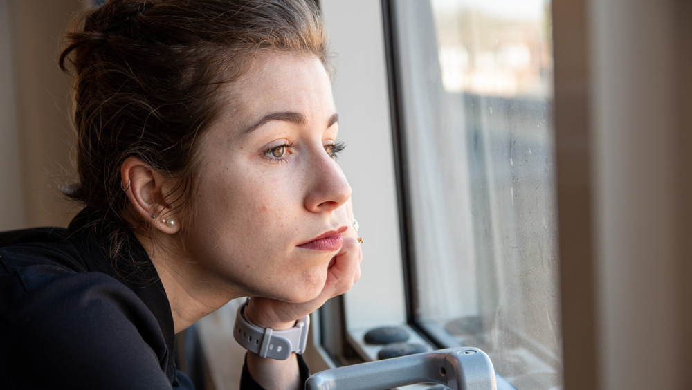 Woman staring out of her window 