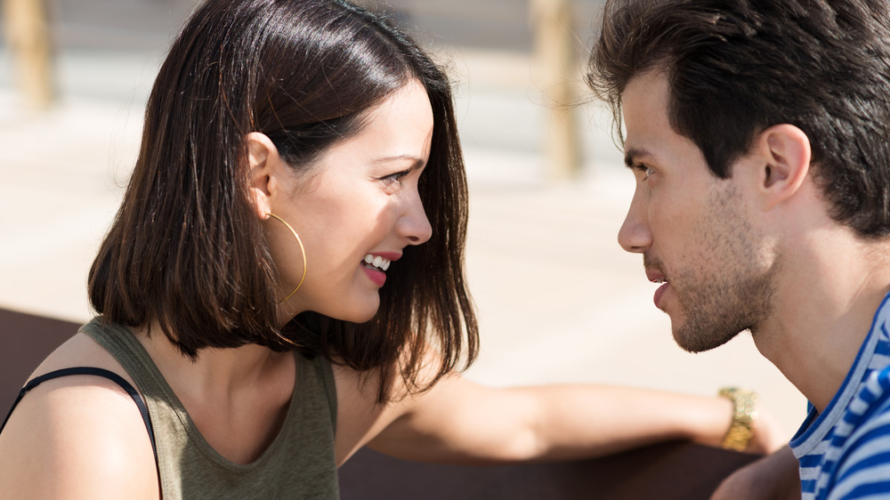  two young people staring into each other's eyes.