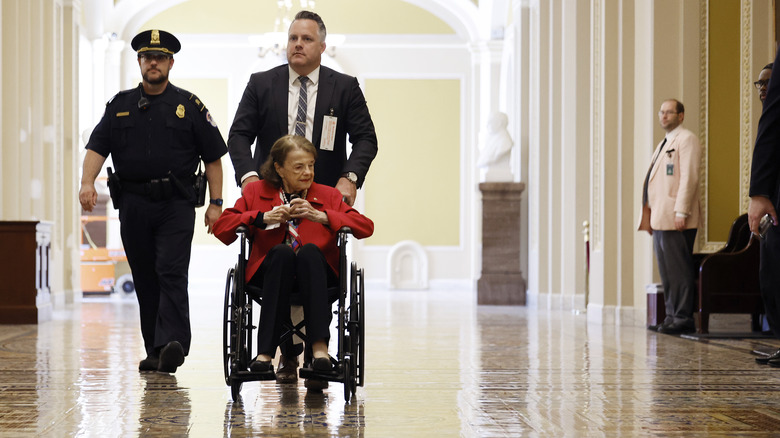 Dianne Feinstein being pushed in a wheelchair