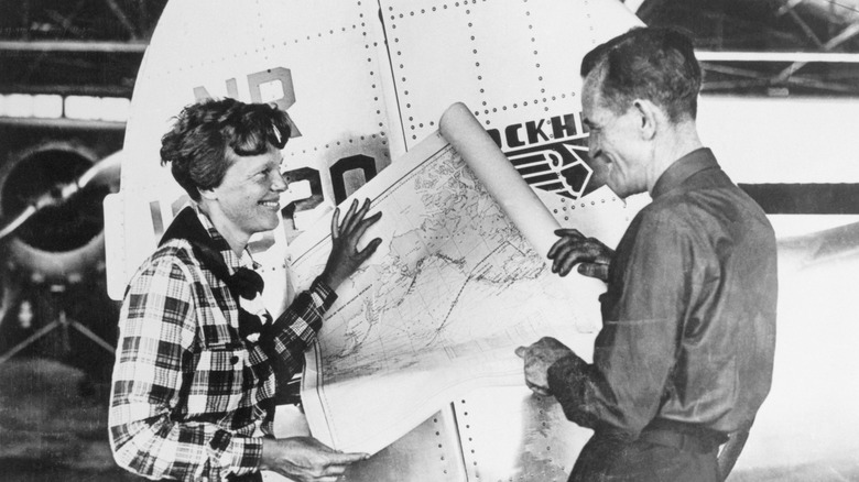 Earhart and Noonan talking by plane