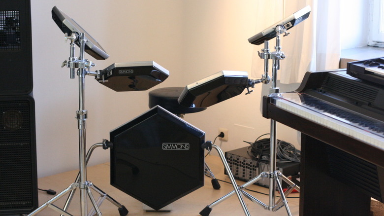 A Simmons SDS5 Drum Kit in a museum with keyboard in foreground