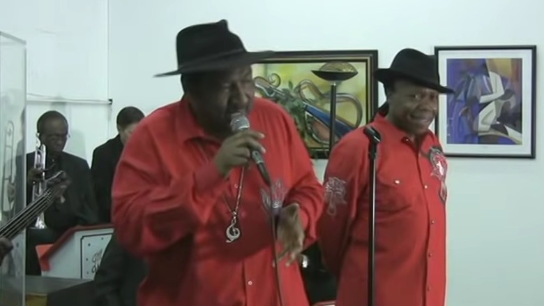 The Winstons performing in red shirts and black hats