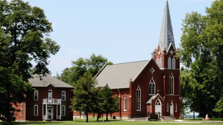 Red brick tall steeple church exterior sunny