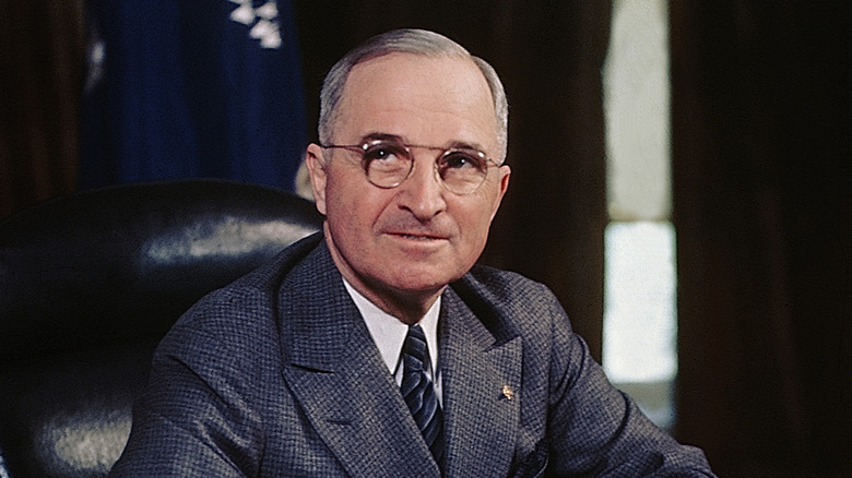 harry truman sitting at presidential desk