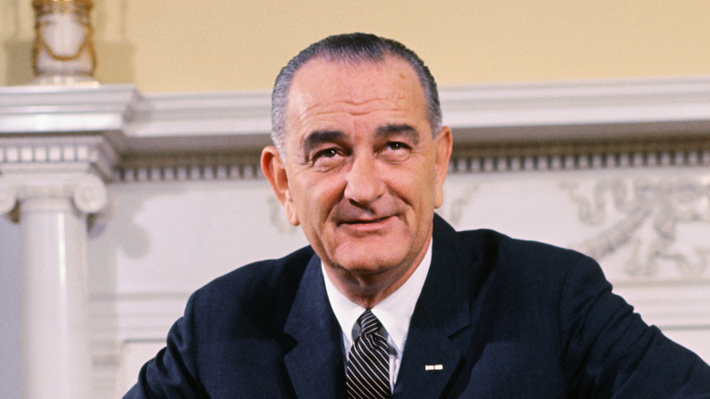 lyndon johnson smiling and looking up in white house family quarters