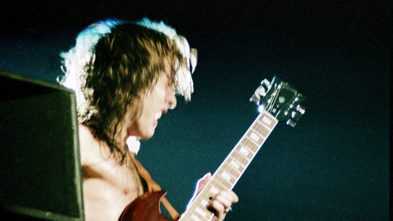 Lead guitarist of AC/DC performing 