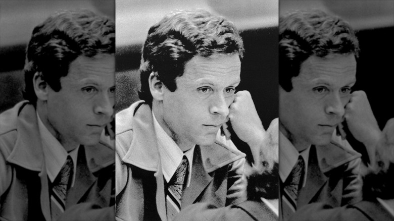 Ted Bundy in tie and jacket with head on hand