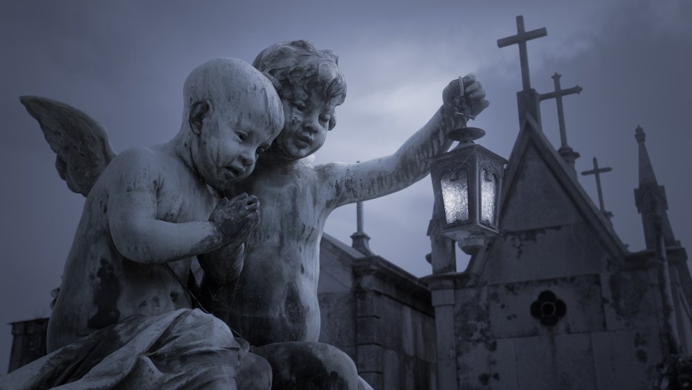 Child angel statues in front of a church