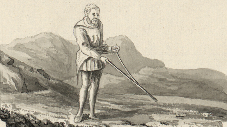 Black and white Elizabethan man with divining rod