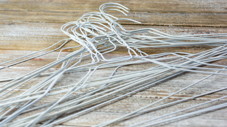 white coat hangers on wood floor