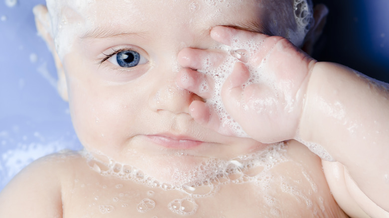 baby covered in soap bubbles