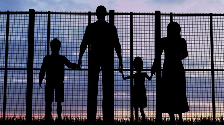 Family behind a fence