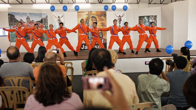 Men dancing in prison uniforms