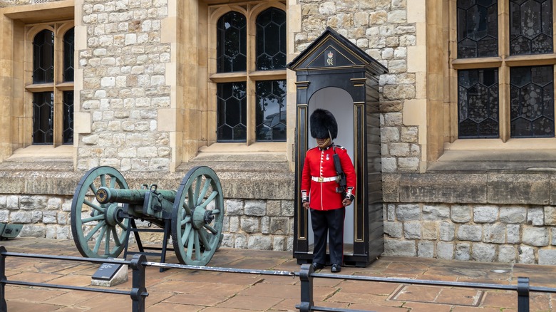 british military guard standing by cannon