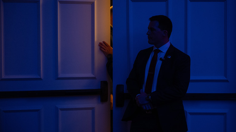 Secret Service agent stands near door