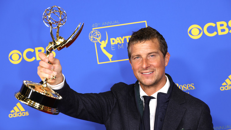 Bear Grylls holding Emmy and smiling