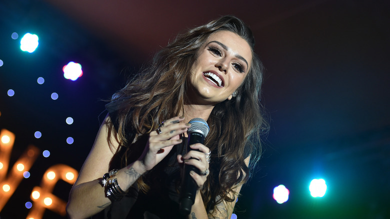 Cher Lloyd singing into microphone