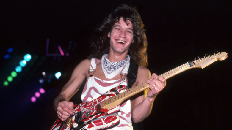 Eddie Van Halen smiling performing onstage