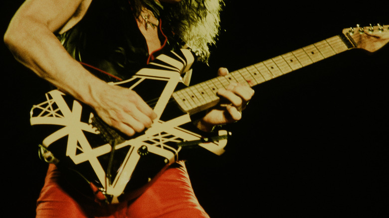 Eddie Van Halen playing striped guitar onstage