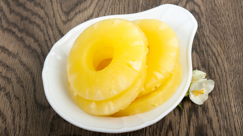 canned pineapple slices in white dish