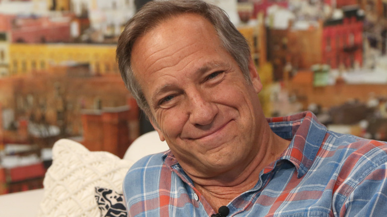 mike rowe leaning on couch plaid shirt