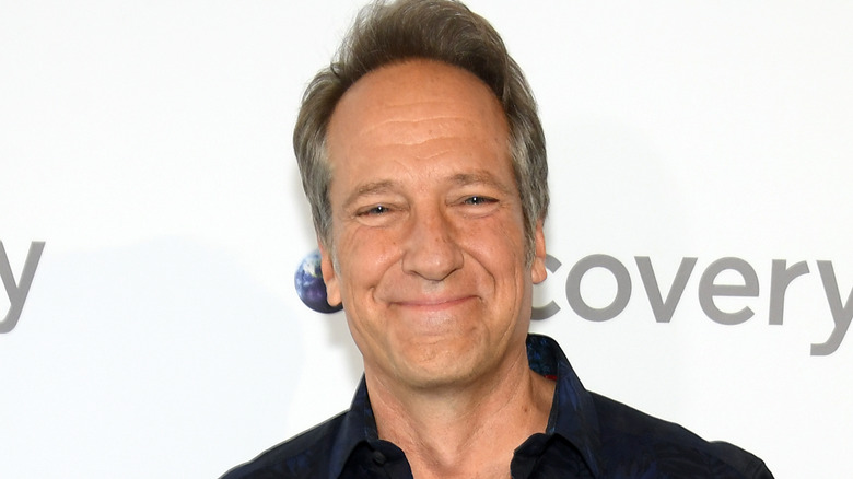 mike rowe smirking discovery backdrop