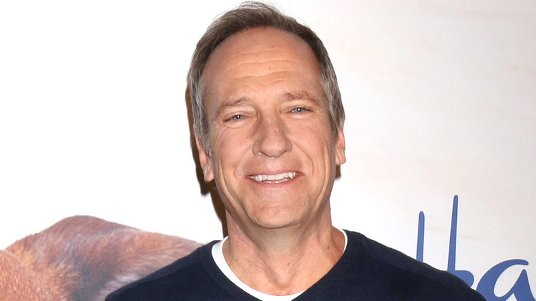 mike rowe head tilted back blue sweater