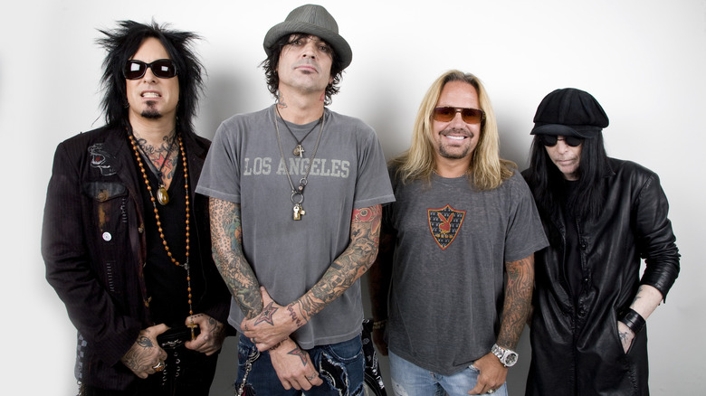 Motley Crue members standing group white background