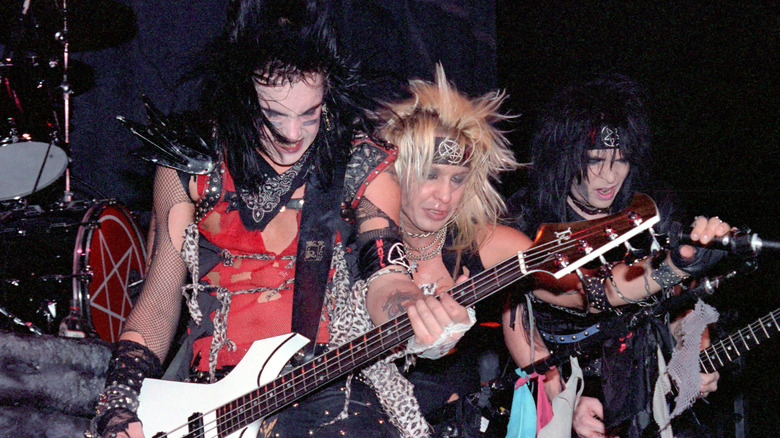 Nikki Sixx, Vince Neil and Mick Mars headbanging on stage