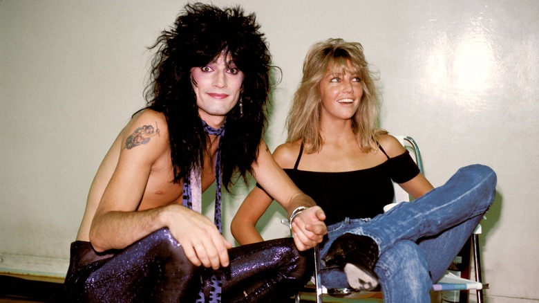 shirtless Tommy Lee sitting with Heather Locklear