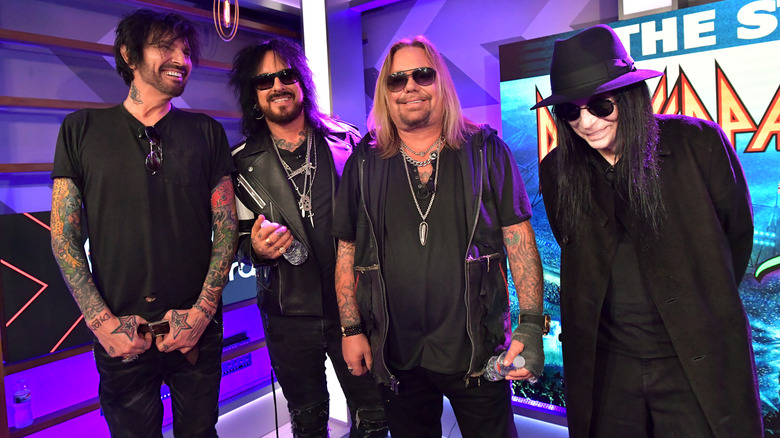 Motley Crue all black smiling group together at event