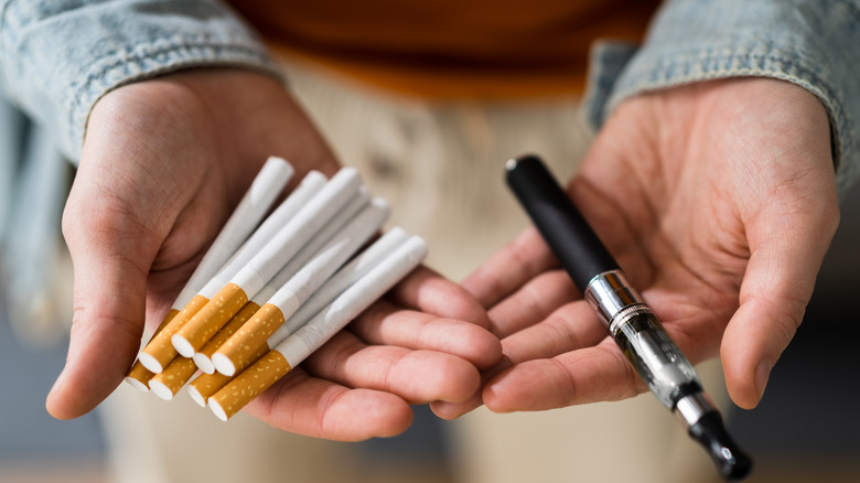 Cigarettes and e-cigarettes in hands