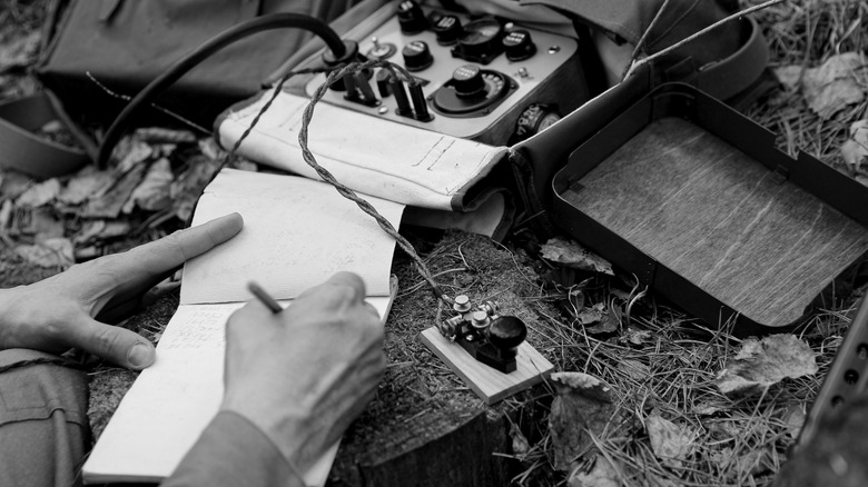 Soldier taking notes from morse code