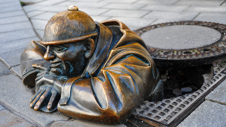 Bronze man sewer statue