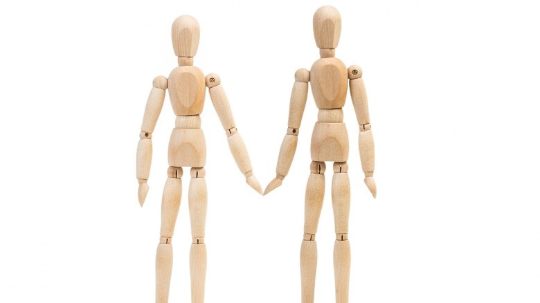 two wooden mannequins 