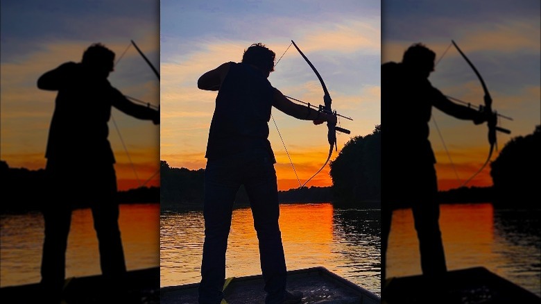 Native American hunting fish with a bow