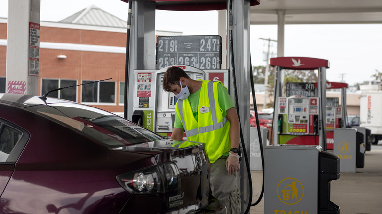 a New Jersey attendant pumps gas