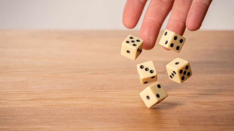 hand throwing dice