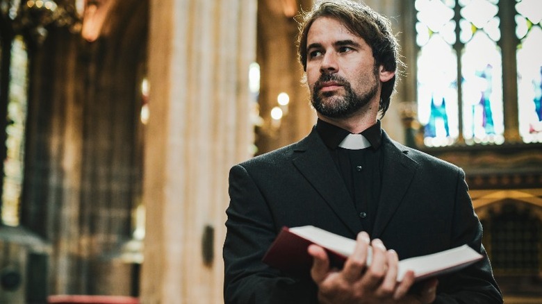 Priest holding bible