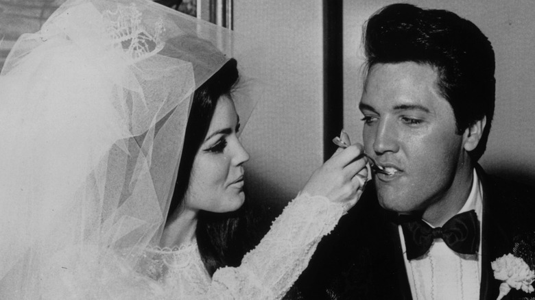 Priscilla feeding Elvis Presley cake at their wedding