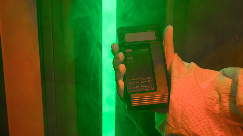 Man with radiation counter measuring levels