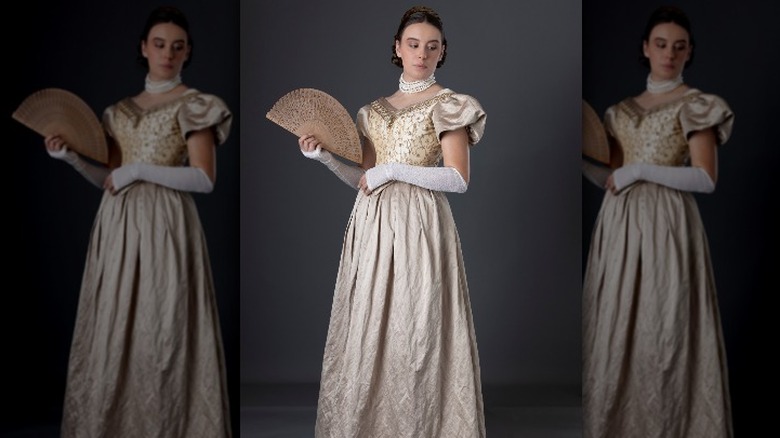 Woman modeling Victorian ballroom fashion