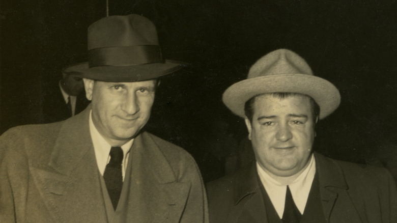 Abbott and Costello pose in suits hats