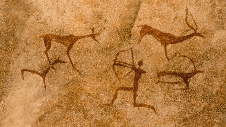 ancient cave painting of prehistoric hunter