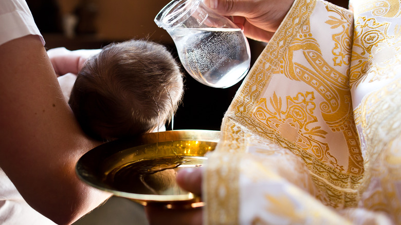 A priest performing a baptism