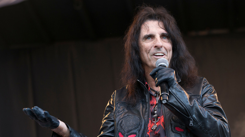 Alice Cooper speaking into mic without makeup