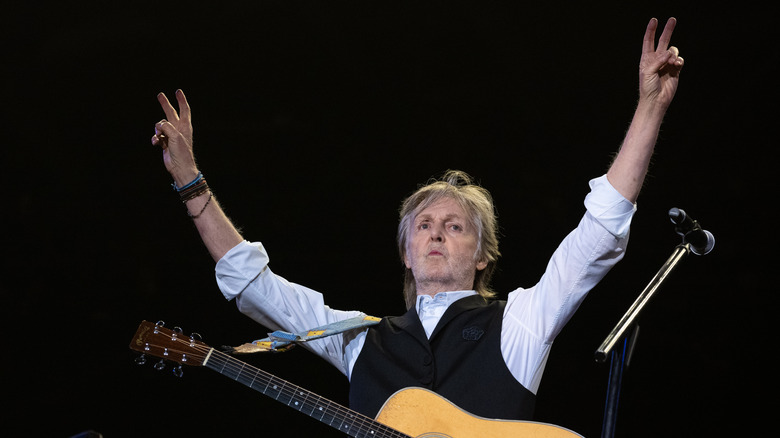 Paul McCartney with hand in the air