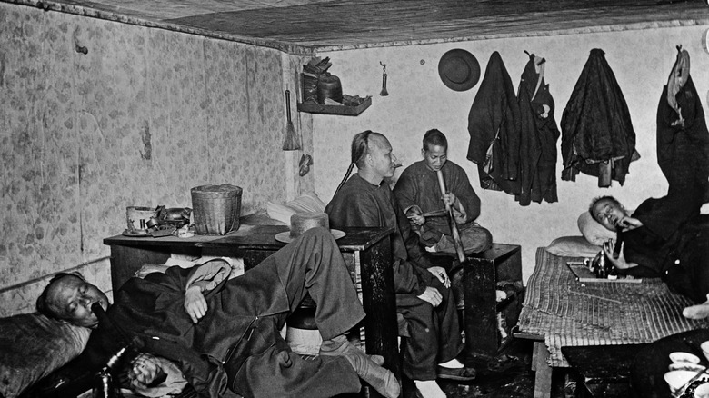 men smoking in opium den